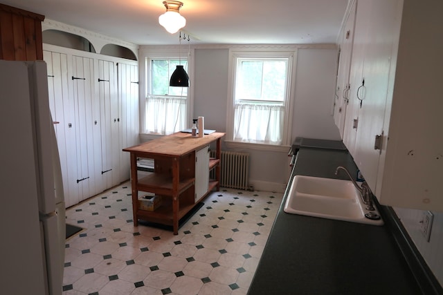 7 Elm St, Augusta, ME 04330 - kitchen featuring radiator heating unit, freestanding refrigerator, a sink, light floors, and baseboards
