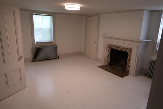 7 Elm St, Augusta, ME 04330 - unfurnished living room with radiator heating unit and a fireplace with flush hearth