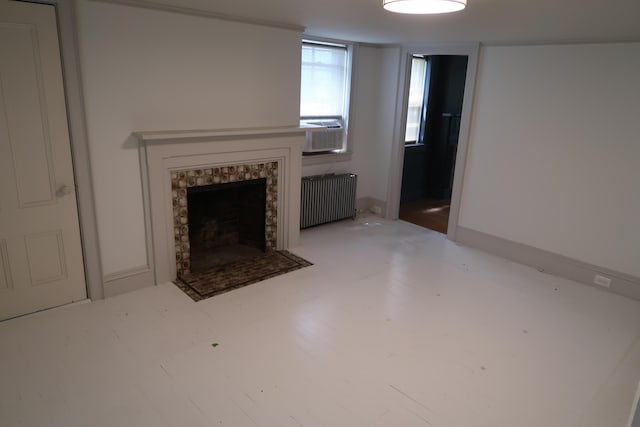 7 Elm St, Augusta, ME 04330 - unfurnished living room featuring radiator, cooling unit, and a fireplace with flush hearth
