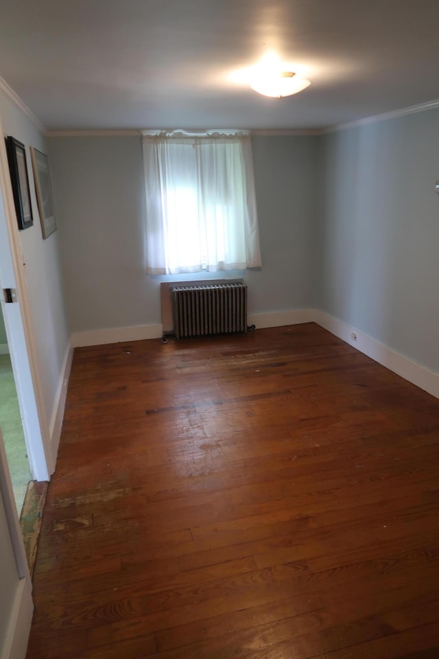 7 Elm St, Augusta, ME 04330 - unfurnished room with radiator, crown molding, wood finished floors, and baseboards