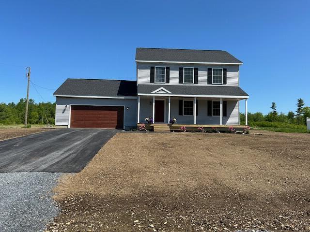 144 Curtis St, Pittsfield, ME 04967 - view of front of home featuring an attached garage, covered porch, and asphalt driveway