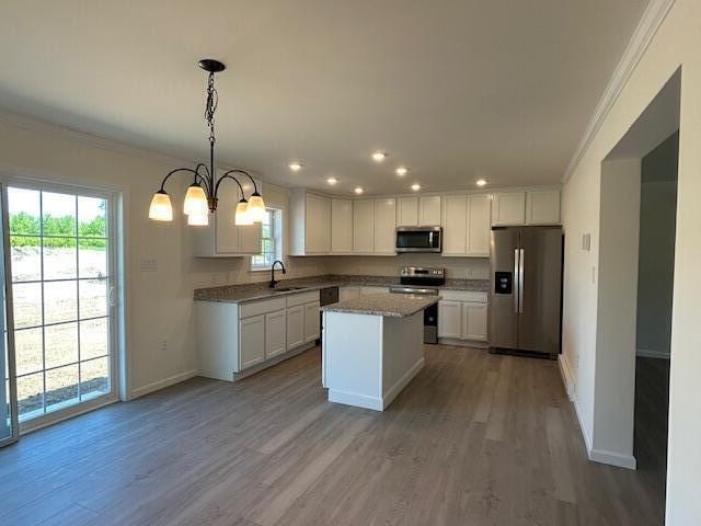 144 Curtis St, Pittsfield, ME 04967 - kitchen with appliances with stainless steel finishes, crown molding, a sink, recessed lighting, and white cabinetry