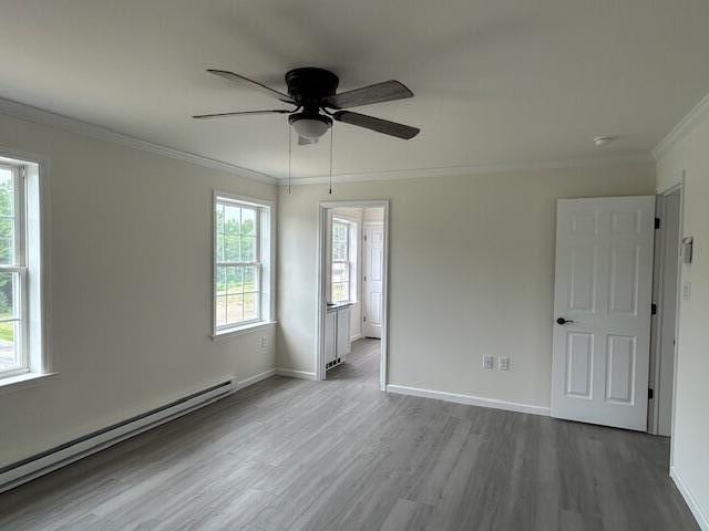 144 Curtis St, Pittsfield, ME 04967 - spare room featuring a baseboard radiator, ornamental molding, wood finished floors, ceiling fan, and baseboards