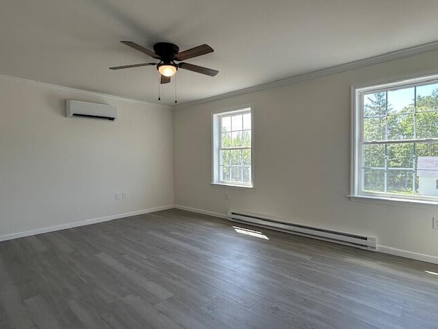 144 Curtis St, Pittsfield, ME 04967 - unfurnished room with a baseboard heating unit, crown molding, an AC wall unit, ceiling fan, and dark wood finished floors