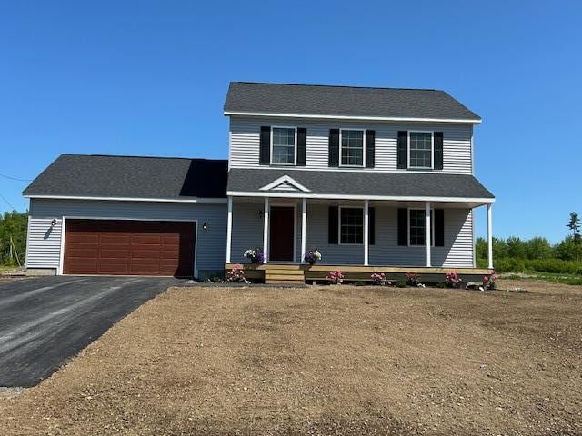 144 Curtis St, Pittsfield, ME 04967 - view of front of home with a garage, driveway, and a porch
