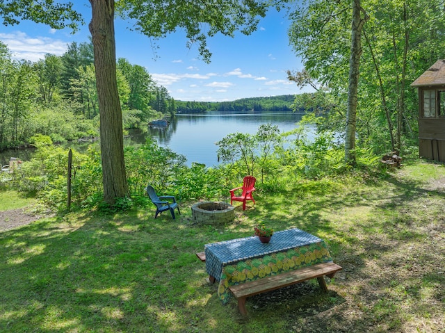 66 Myron Hall Rd, Raymond, ME 04071 - view of green lawn featuring an outdoor fire pit, a water view, and a wooded view