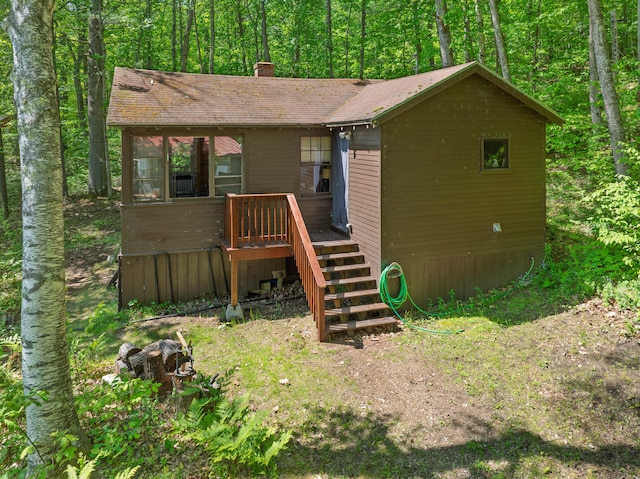 66 Myron Hall Rd, Raymond, ME 04071 - rear view of house featuring a chimney, stairs, and a forest view