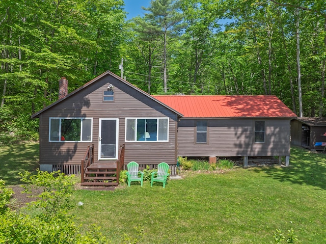 66 Myron Hall Rd, Raymond, ME 04071 - rear view of property featuring metal roof, a lawn, and a chimney