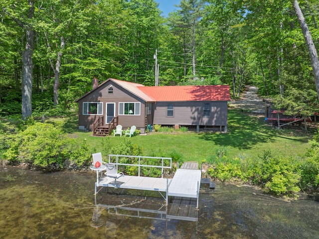 66 Myron Hall Rd, Raymond, ME 04071 - back of house featuring metal roof, a yard, entry steps, and a wooded view