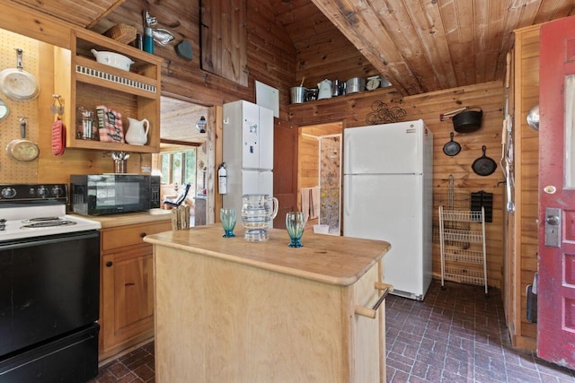 66 Myron Hall Rd, Raymond, ME 04071 - kitchen with freestanding refrigerator, range with electric stovetop, black microwave, brick patterned floors, and wooden walls