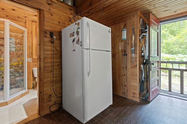 66 Myron Hall Rd, Raymond, ME 04071 - kitchen featuring freestanding refrigerator, brick patterned flooring, wooden walls, and wood ceiling