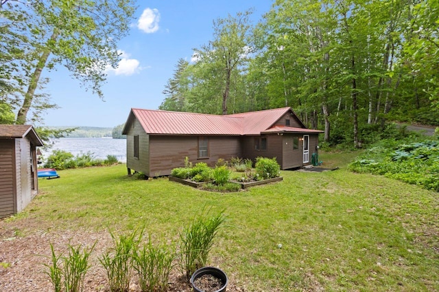 66 Myron Hall Rd, Raymond, ME 04071 - back of property with a yard, a water view, and metal roof