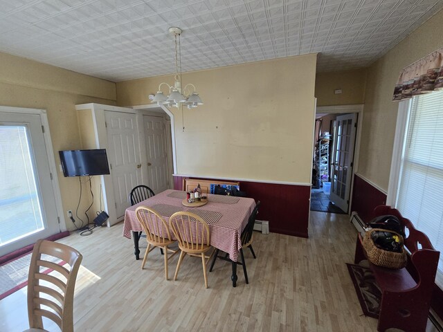 25 Jarvis Gore Dr, Eddington, ME 04428 - dining space with light wood finished floors, baseboard heating, a chandelier, plenty of natural light, and an ornate ceiling