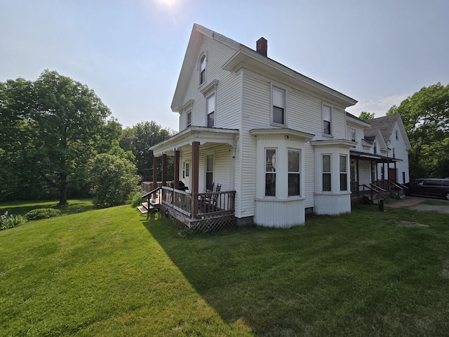 25 Jarvis Gore Dr, Eddington, ME 04428 - view of side of home featuring a chimney, a yard, and a porch