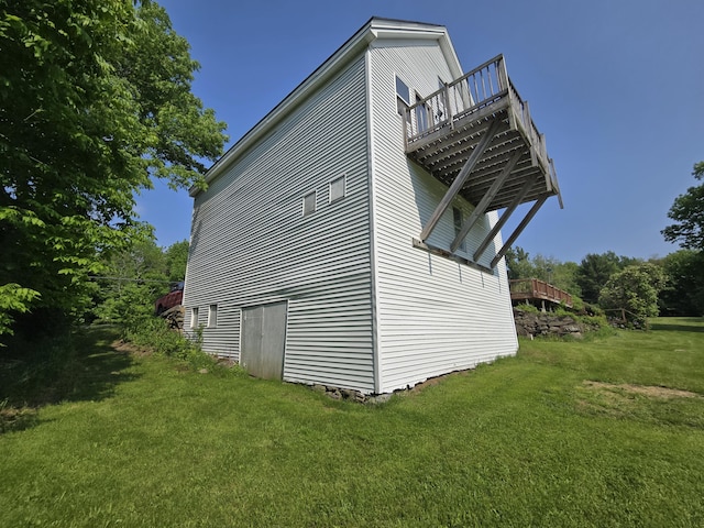 25 Jarvis Gore Dr, Eddington, ME 04428 - view of side of home with a lawn and a deck