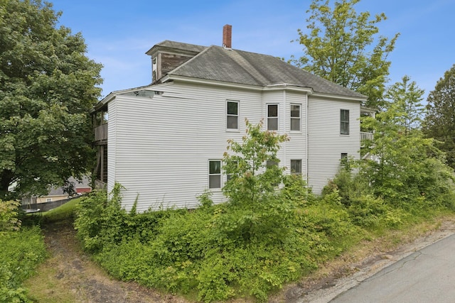 9 Maple St, Jay, ME 04239 - view of property exterior featuring a chimney and roof with shingles