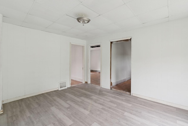 9 Maple St, Jay, ME 04239 - unfurnished room featuring a paneled ceiling and wood finished floors