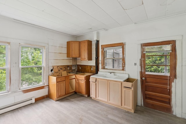 9 Maple St, Jay, ME 04239 - kitchen featuring a baseboard heating unit, healthy amount of natural light, and light wood finished floors