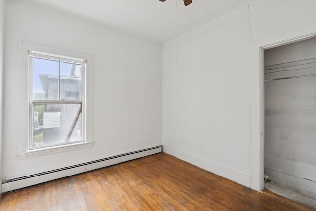 9 Maple St, Jay, ME 04239 - unfurnished bedroom with a baseboard radiator, a closet, and wood finished floors