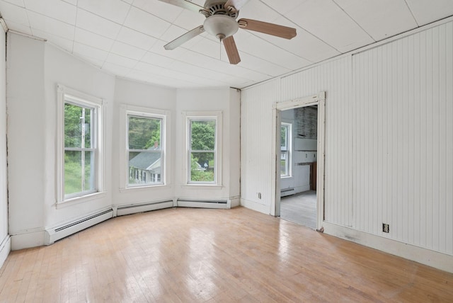 9 Maple St, Jay, ME 04239 - empty room with hardwood / wood-style flooring, ceiling fan, and baseboard heating