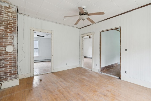 9 Maple St, Jay, ME 04239 - spare room featuring a baseboard heating unit, wood finished floors, ceiling fan, and crown molding
