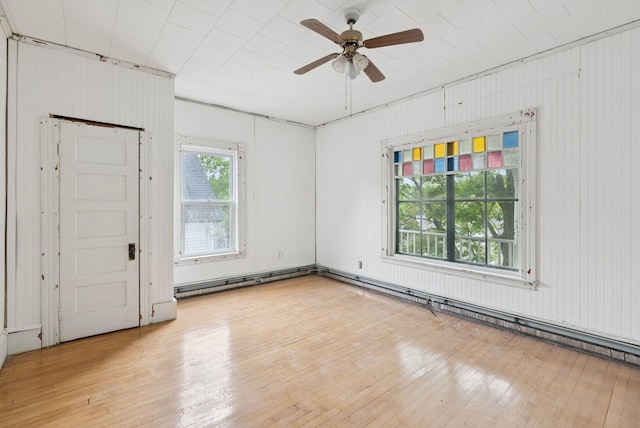 9 Maple St, Jay, ME 04239 - spare room with light wood-style floors, ceiling fan, and wooden walls
