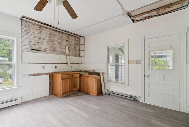 9 Maple St, Jay, ME 04239 - kitchen with light wood finished floors, plenty of natural light, a ceiling fan, and a baseboard heating unit