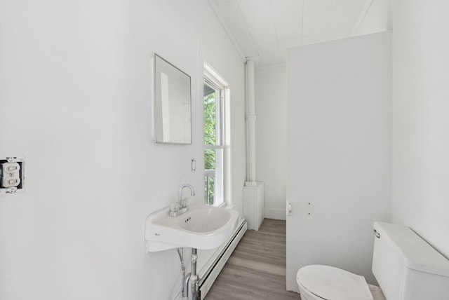 9 Maple St, Jay, ME 04239 - bathroom featuring a baseboard heating unit and wood finished floors