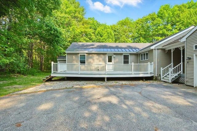 14 Goshen Ln, New Gloucester, ME 04260 - view of front of house with a wooden deck, a standing seam roof, and metal roof