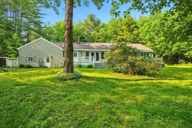 14 Goshen Ln, New Gloucester, ME 04260 - rear view of house featuring a yard, a chimney, and a wooden deck