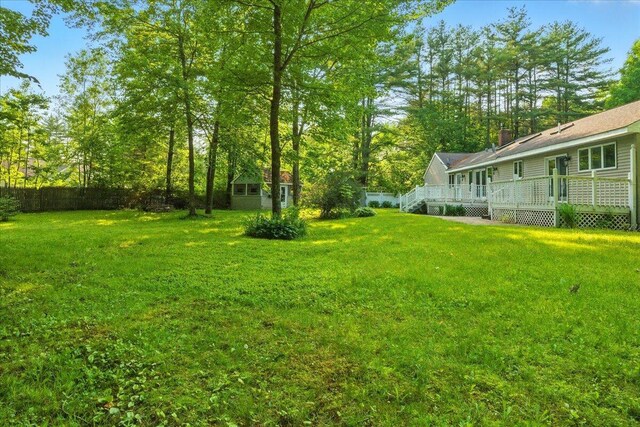 14 Goshen Ln, New Gloucester, ME 04260 - view of grassy yard featuring a wooden deck and an outdoor structure