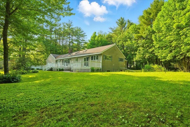 14 Goshen Ln, New Gloucester, ME 04260 - back of house with a yard, a chimney, and covered porch