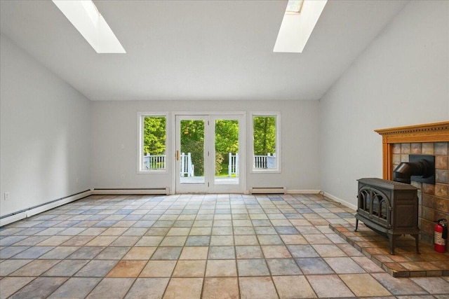 14 Goshen Ln, New Gloucester, ME 04260 - unfurnished living room featuring a skylight, a wood stove, healthy amount of natural light, a baseboard heating unit, and lofted ceiling