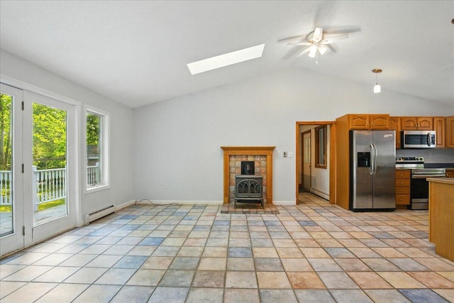 14 Goshen Ln, New Gloucester, ME 04260 - unfurnished living room with a baseboard heating unit, a wood stove, a skylight, vaulted ceiling, and a ceiling fan