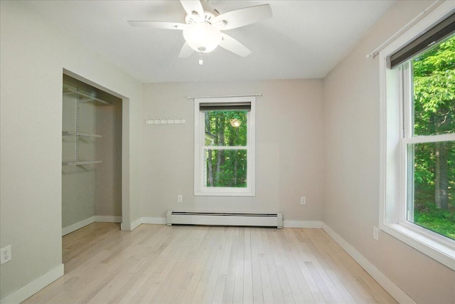 14 Goshen Ln, New Gloucester, ME 04260 - unfurnished bedroom with a baseboard radiator, multiple windows, and wood finished floors
