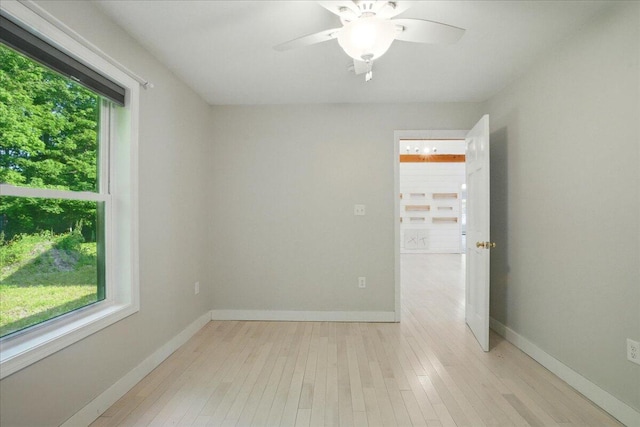 14 Goshen Ln, New Gloucester, ME 04260 - empty room with healthy amount of natural light, light wood-style floors, a ceiling fan, and baseboards