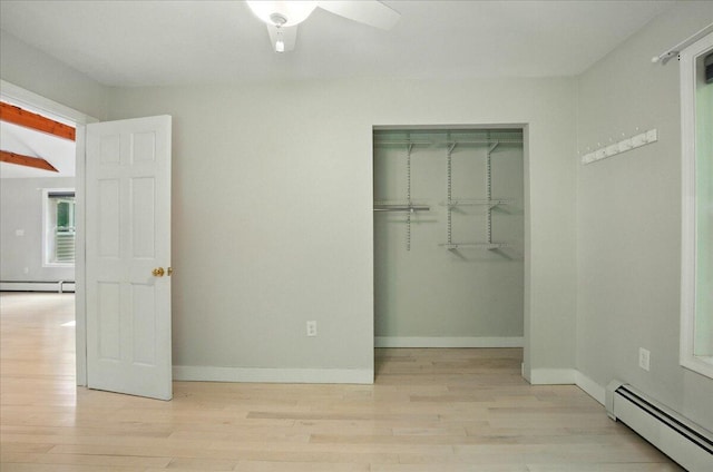 14 Goshen Ln, New Gloucester, ME 04260 - unfurnished bedroom featuring a baseboard heating unit, light wood-style flooring, a closet, baseboards, and ceiling fan