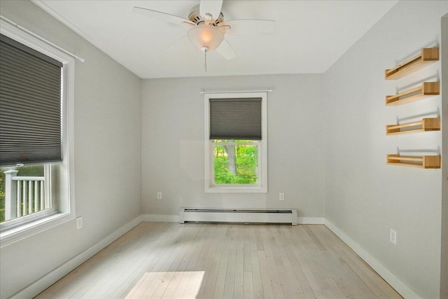 14 Goshen Ln, New Gloucester, ME 04260 - empty room with baseboard heating, plenty of natural light, wood-type flooring, and baseboards