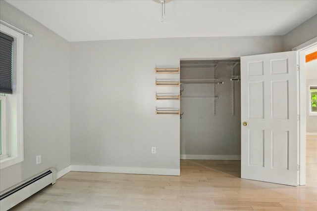 14 Goshen Ln, New Gloucester, ME 04260 - unfurnished bedroom with baseboard heating, wood finished floors, and baseboards