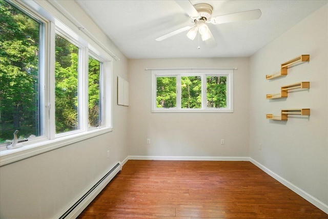 14 Goshen Ln, New Gloucester, ME 04260 - spare room featuring wood finished floors, baseboards, a ceiling fan, and a baseboard heating unit