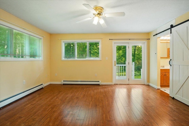 14 Goshen Ln, New Gloucester, ME 04260 - unfurnished room with a baseboard heating unit, a barn door, and plenty of natural light