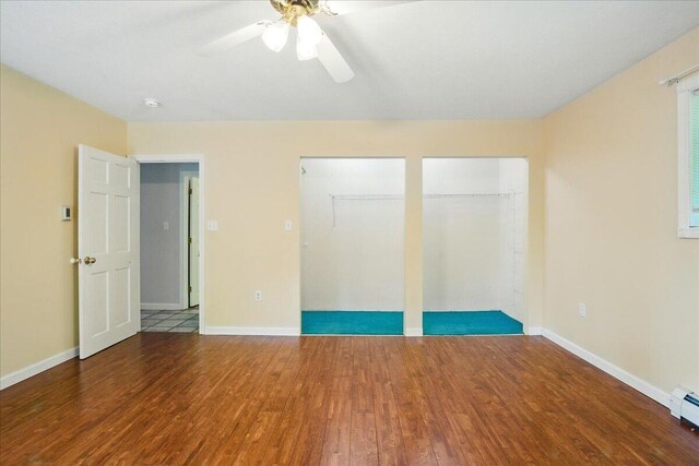 14 Goshen Ln, New Gloucester, ME 04260 - unfurnished bedroom featuring wood finished floors, baseboards, a ceiling fan, and multiple closets