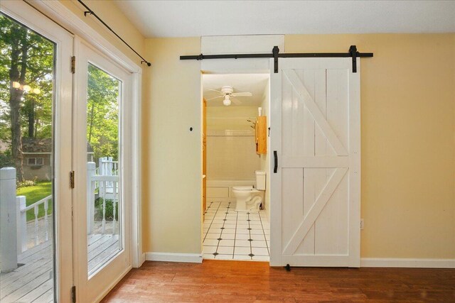 14 Goshen Ln, New Gloucester, ME 04260 - doorway with a barn door, baseboards, and wood finished floors