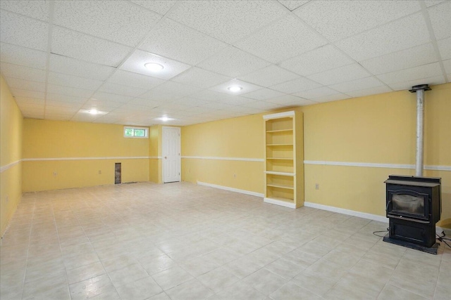 14 Goshen Ln, New Gloucester, ME 04260 - below grade area featuring a wood stove, a paneled ceiling, and recessed lighting