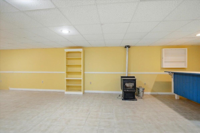 14 Goshen Ln, New Gloucester, ME 04260 - finished basement with a wood stove, baseboards, light tile patterned flooring, a paneled ceiling, and recessed lighting