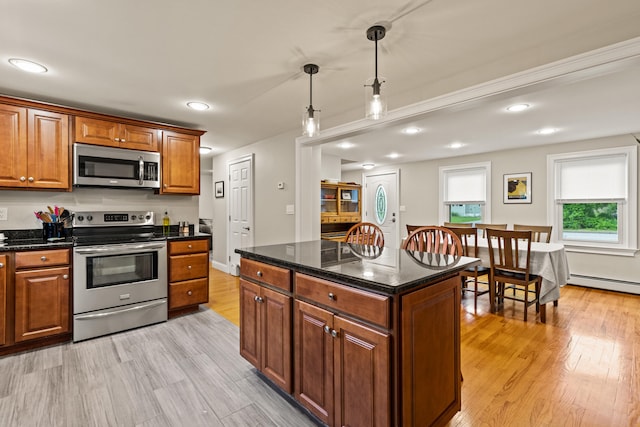 534 Summit St, Portland, ME 04103 - kitchen featuring appliances with stainless steel finishes, light wood-style floors, brown cabinetry, a baseboard radiator, and recessed lighting