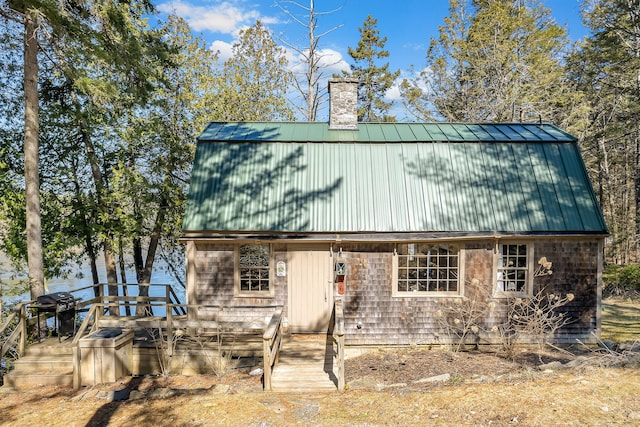 36 Hodgdon Rd, Westport Island, ME 04578 - view of front of house with a chimney, metal roof, and a deck