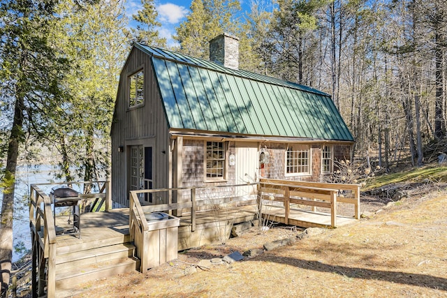 36 Hodgdon Rd, Westport Island, ME 04578 - view of front of property featuring a chimney, a standing seam roof, metal roof, and a deck