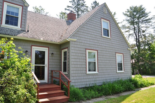 5 Charles St, Orono, ME 04473 - back of property with a chimney and a shingled roof