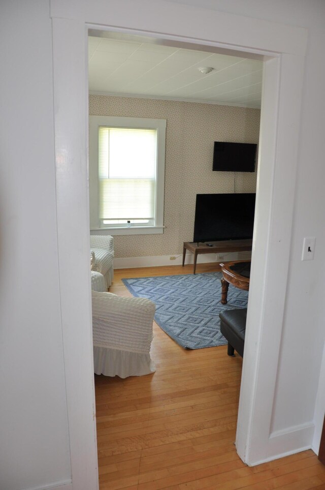 5 Charles St, Orono, ME 04473 - living area featuring wallpapered walls, light wood finished floors, and baseboards